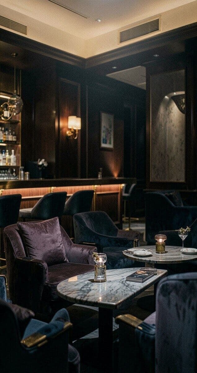 Velvet lounge with marble tables and warm ambient lighting